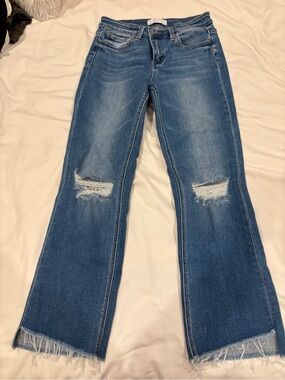 Mid-Rise Distressed Flare Jeans in Mid Blue
